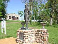 park with statue and cabin